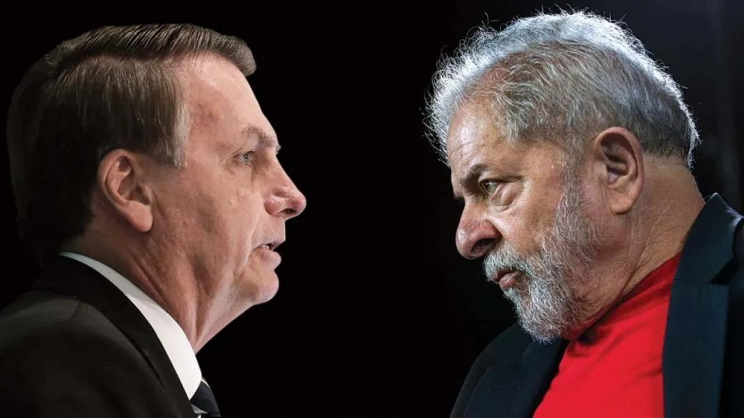 O presidente Bolsonaro, branco, com cabelos grisalhos, terno preto, gravata preta e camisa branca, está de frente para Lula, branco, de cabelos e barba branca. Lula usa um casaco preto e uma blusa vermelha. Os dois se olham.